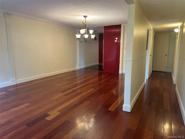 a kitchen with a sink a refrigerator and wooden floor