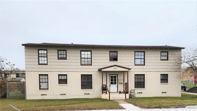 a view of a white house with large windows