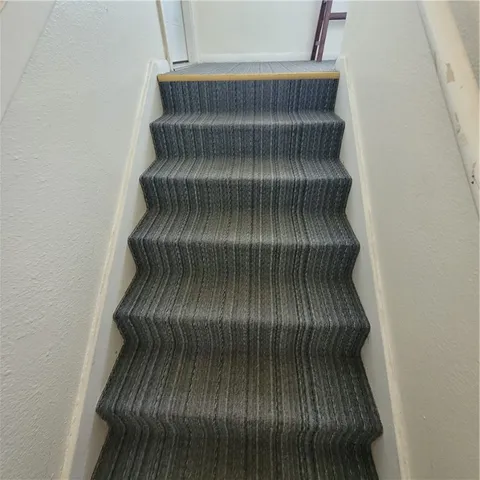 a view of staircase with white walls