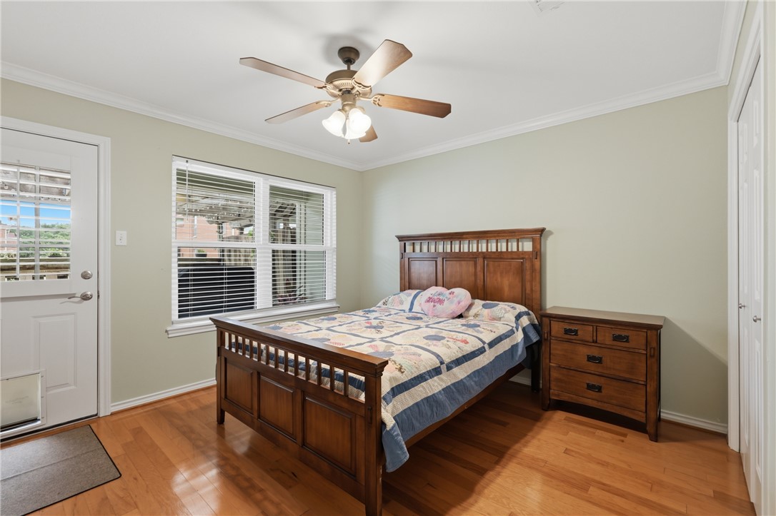 1520 Bennett Street Bryan, TX 77802 - Photo 17 of 24 a bedroom with a bed and wooden floor