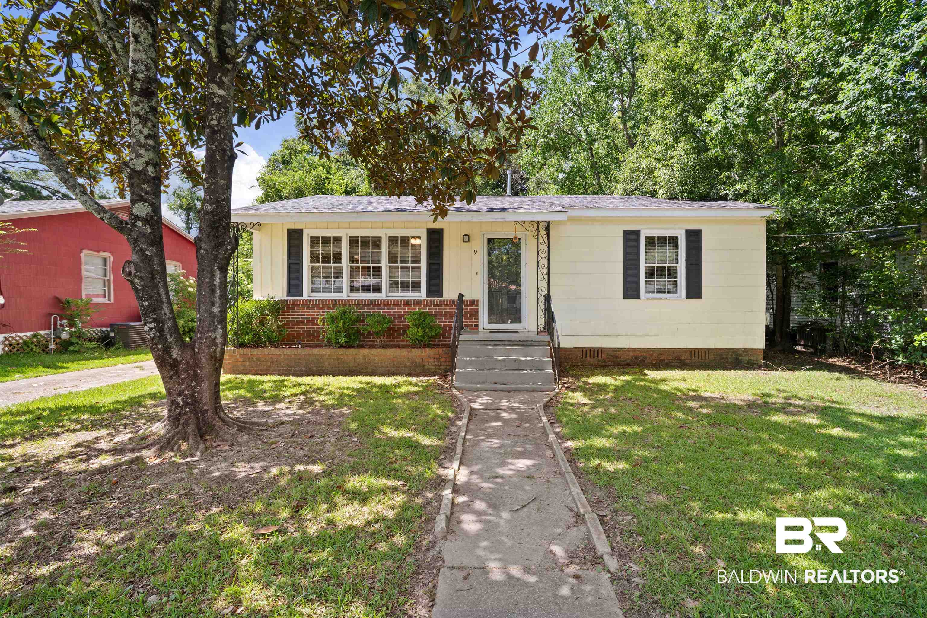 9 Elizabeth Avenue Mobile, AL 36611 - Photo 1 of 19 View of front facade with a front yard and board and batten siding