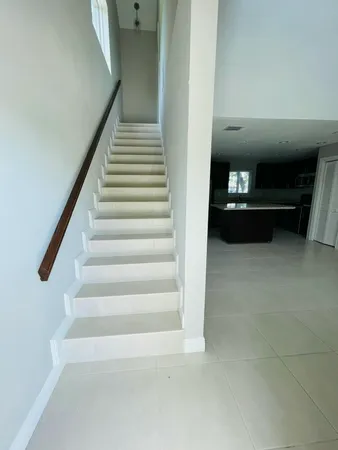 a large kitchen with stainless steel appliances granite countertop a large counter top and a stove top oven