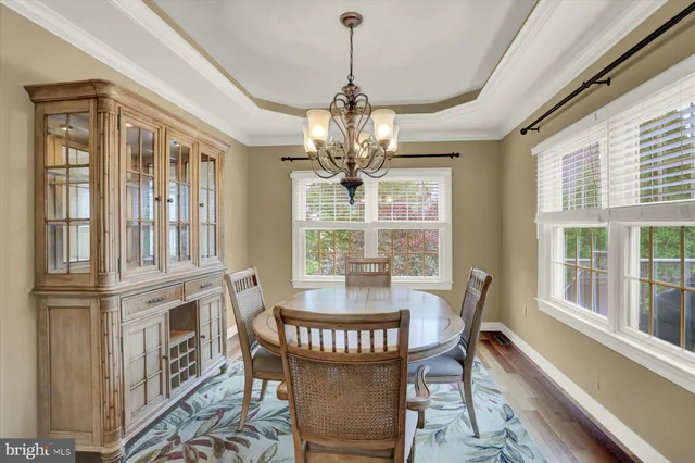 a view of a dining room with furniture wooden floor and chandelier