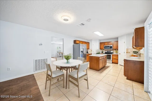 a view of a dining room with furniture and a kitchen