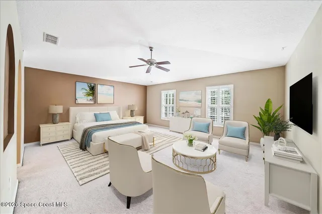 a bedroom with furniture and a flat screen tv