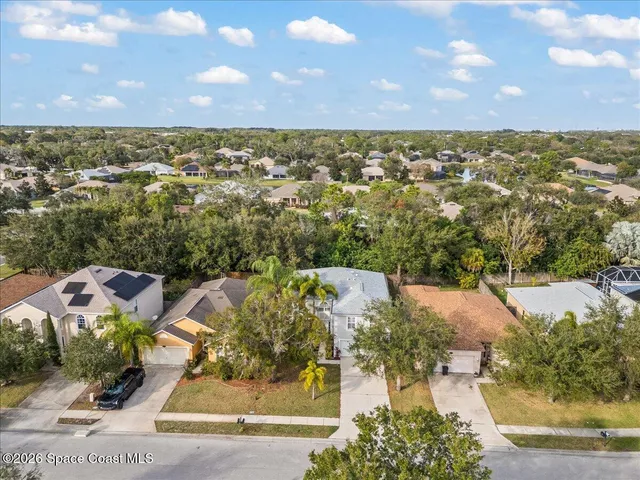an aerial view of residential houses with outdoor space and river