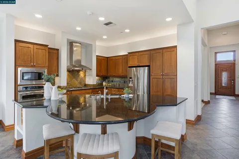 a view of a dining room with furniture and a chandelier
