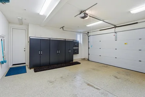 a view of a patio with a table and chairs under an umbrella