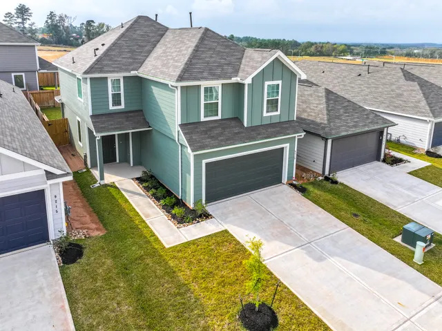 an aerial view of a house with a yard