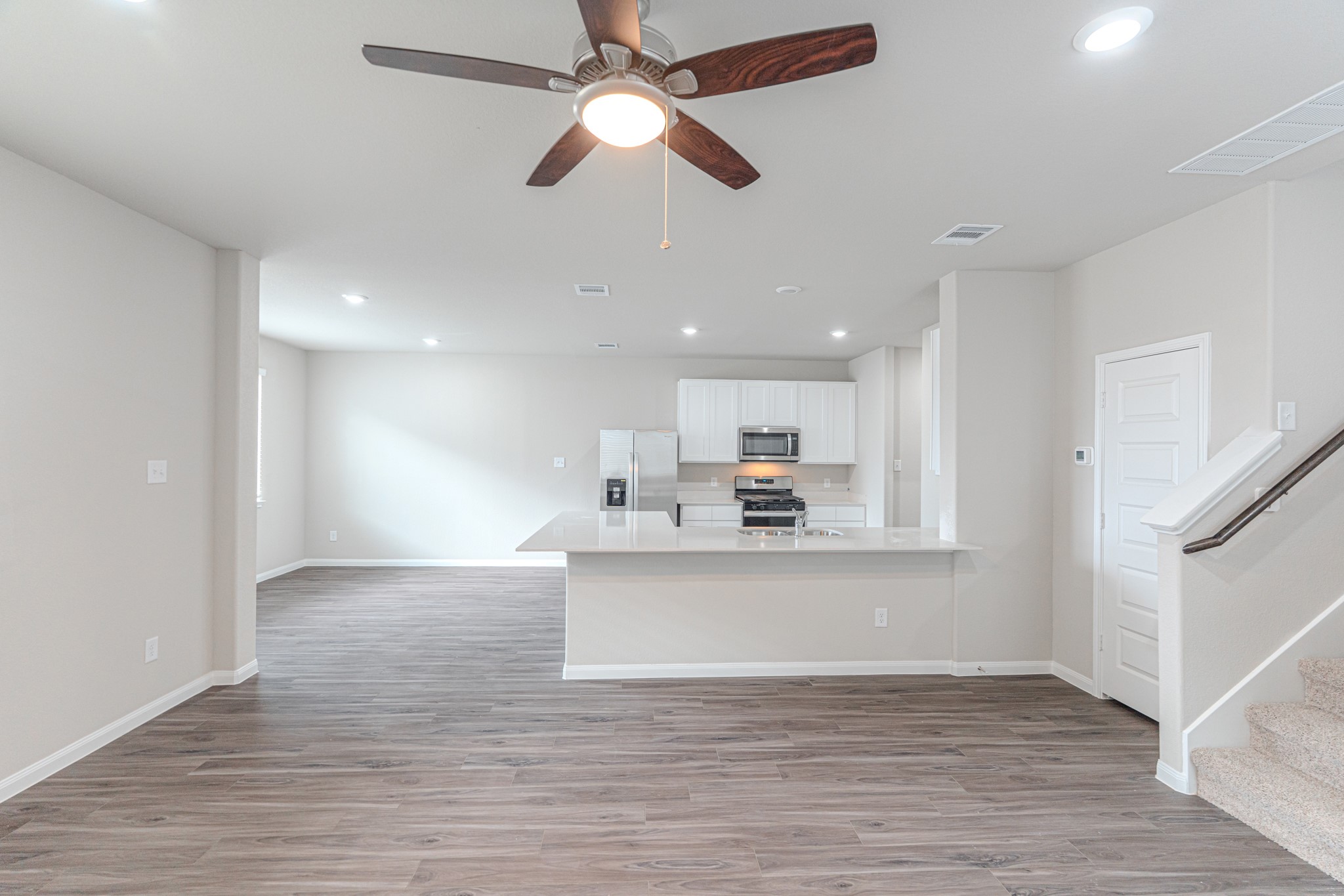 9219 Grace Rdg Drive Willis, TX 77318 - Photo 11 of 44 a view of kitchen with kitchen island wooden floor and ceiling fan