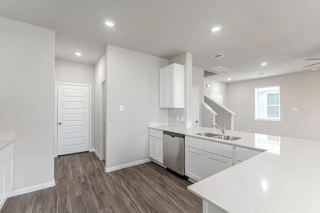 a kitchen with a sink stainless steel appliances and cabinets