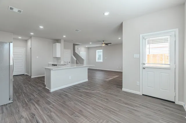 a view of kitchen and kitchen with wooden floor