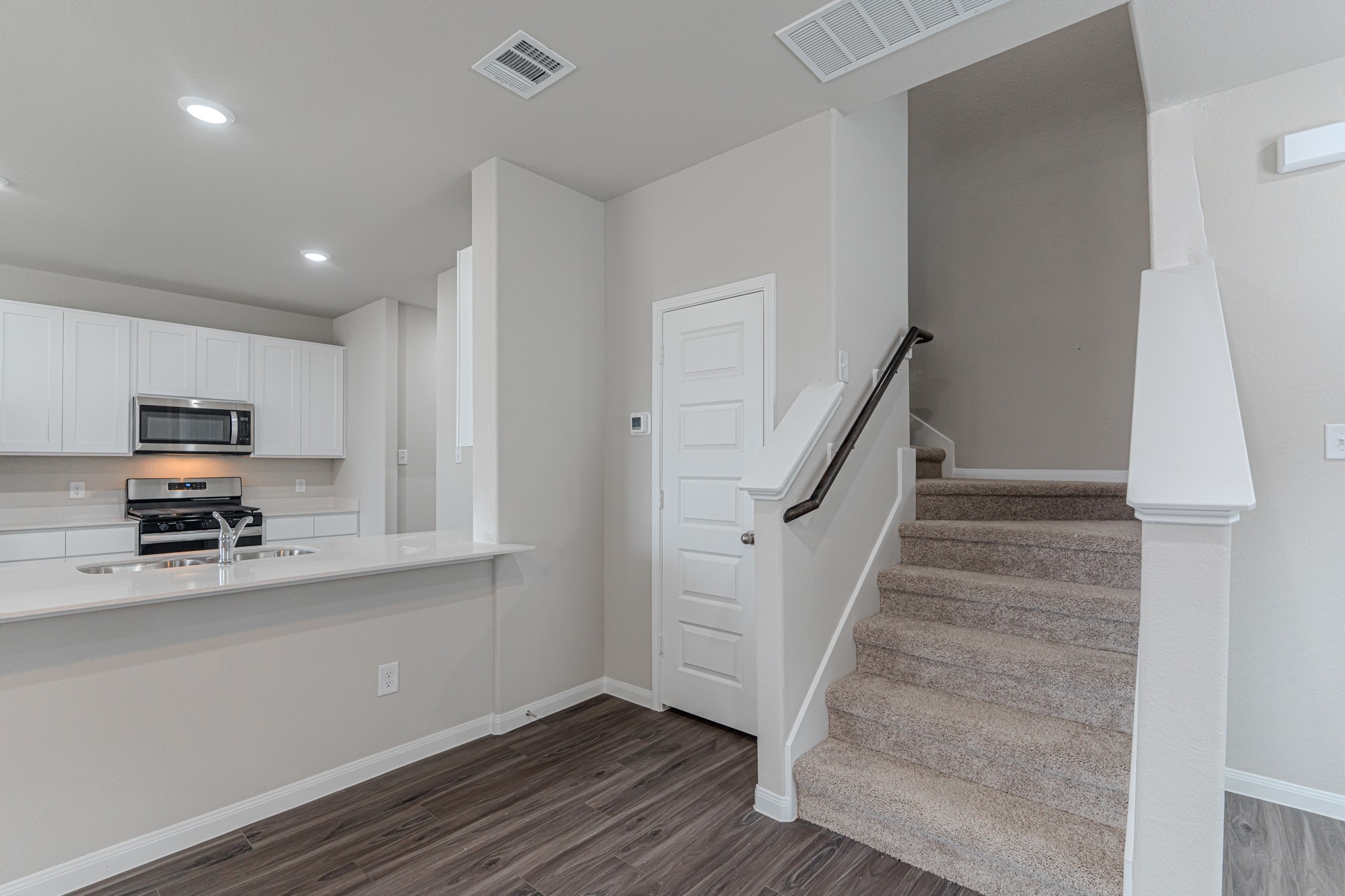 9219 Grace Rdg Drive Willis, TX 77318 - Photo 25 of 44 a view of a kitchen with wooden floor and electronic appliances