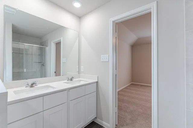 a bathroom with 2 sink and a mirror