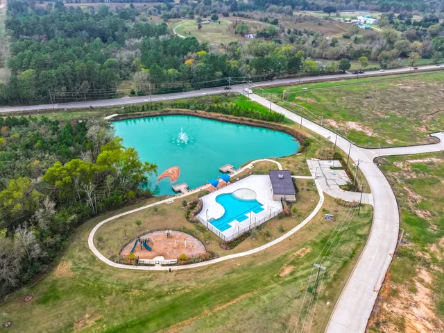 a view of a swimming pool with a yard and seating
