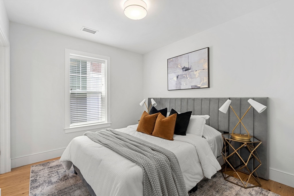 30 Polk Street, Unit 208 Boston, MA 02129 - Photo 13 of 24 a bedroom with a bed and a window