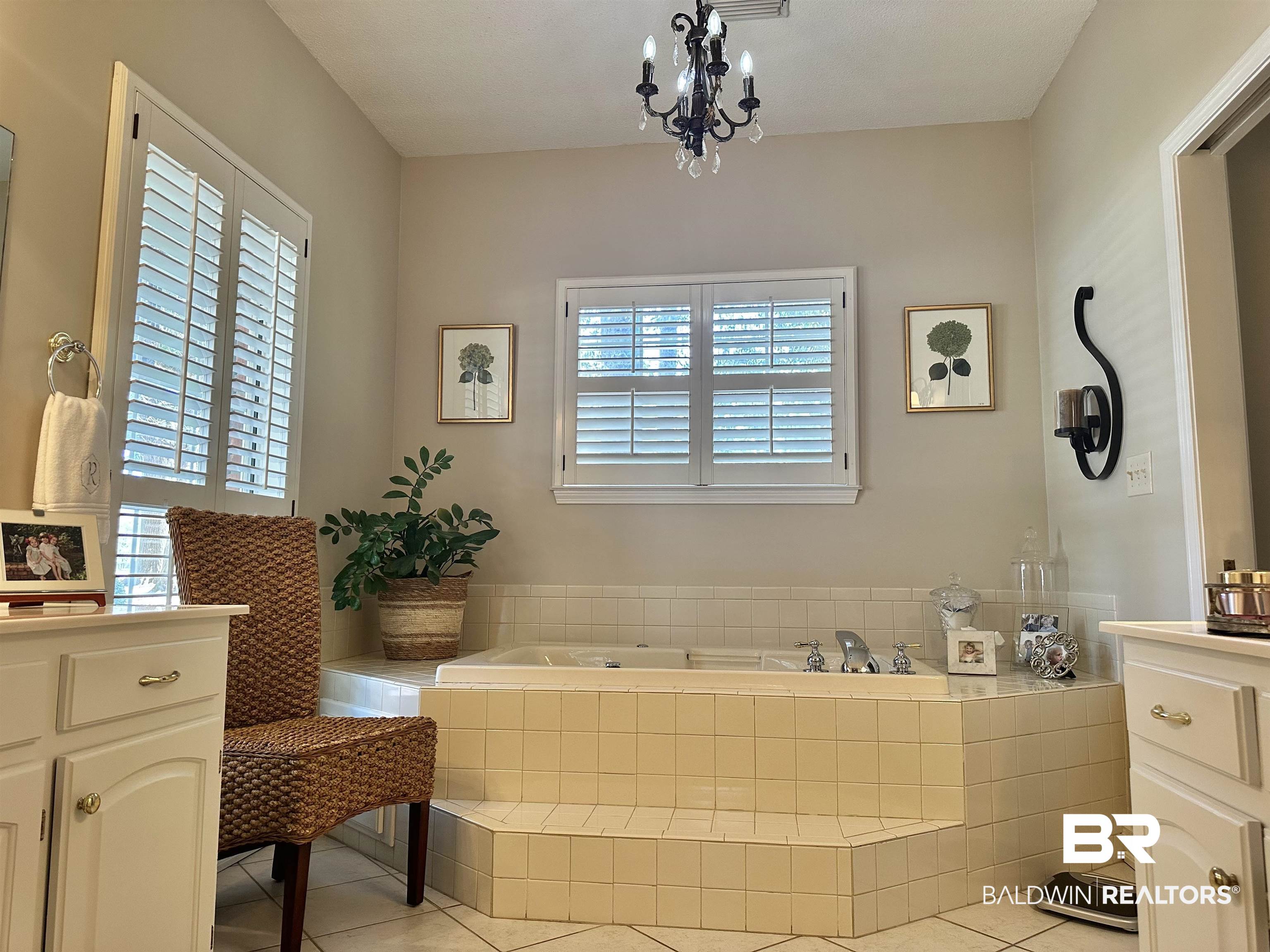 148 Brooks Boulevard Brewton, AL 36426 - Photo 22 of 45 Bathroom featuring a wealth of natural light, a chandelier, tile patterned flooring, and a bath