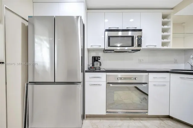 a kitchen with a refrigerator and a microwave