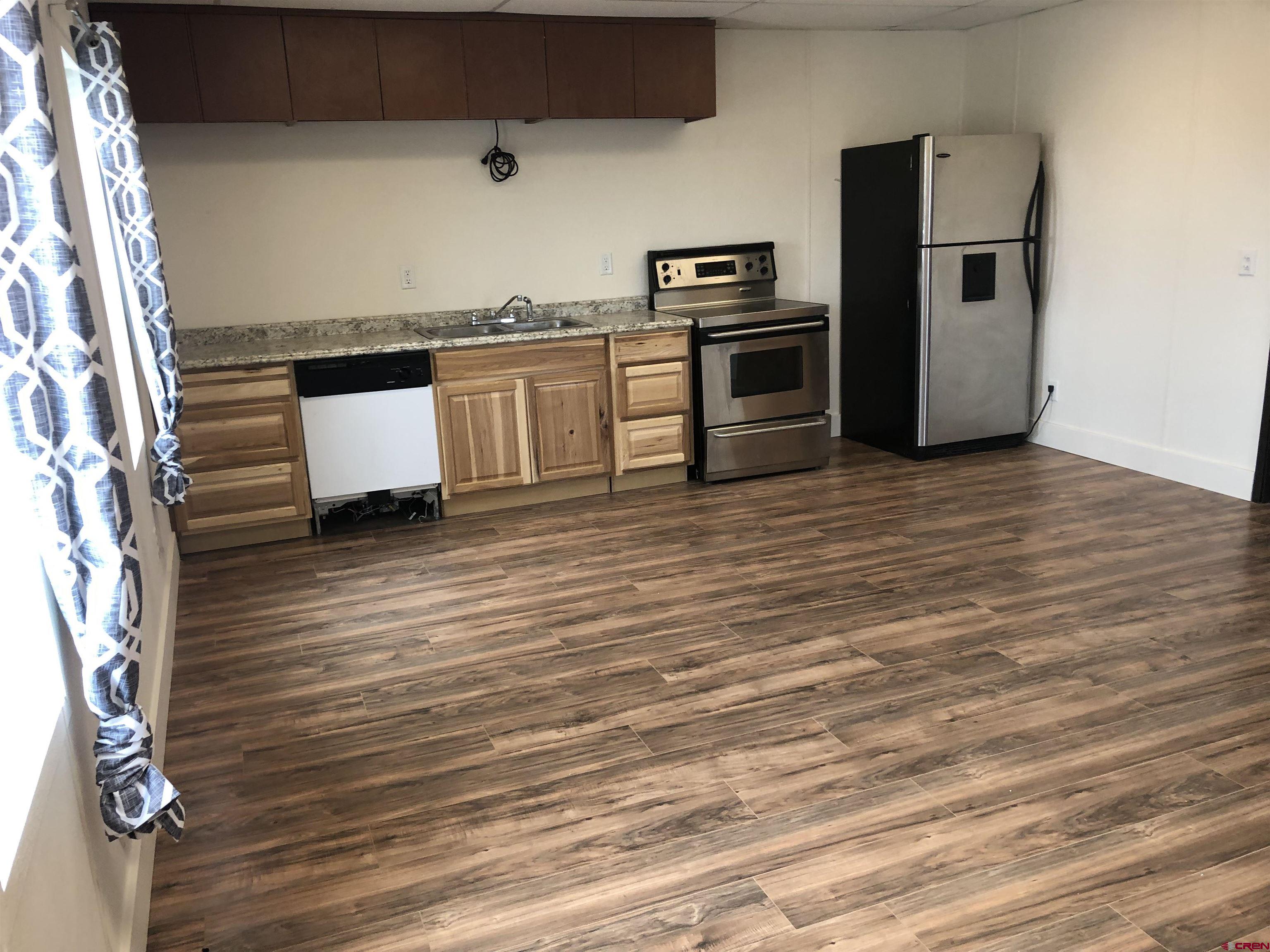 5123 Flint Delta, CO 81416 - Photo 12 of 24 a kitchen with stainless steel appliances a refrigerator sink and stove