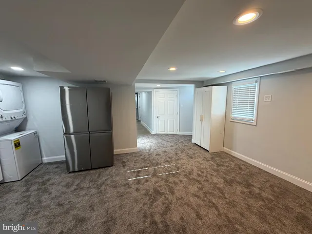 a view of a livingroom with a refrigerator