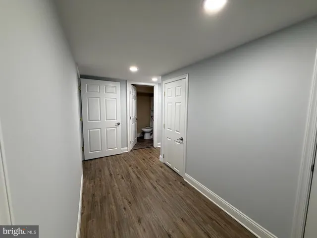 a view of hallway with wooden floor