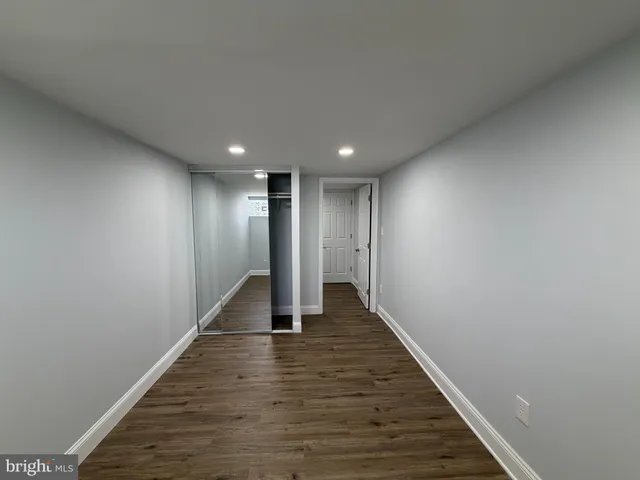 a view of hallway with wooden floor