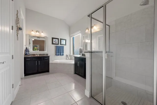 a large bathroom with a double vanity sink a toilet and a shower