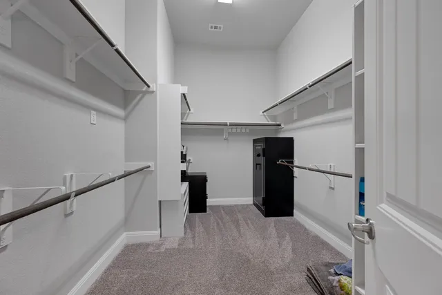 a view of a storage & utility room with refrigerator