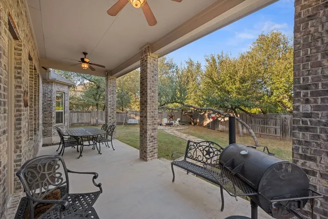a balcony with furniture and a potted plant