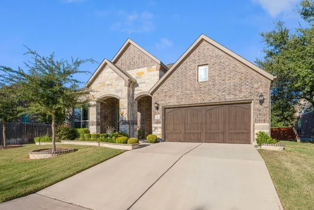 a front view of a house with a yard and garage