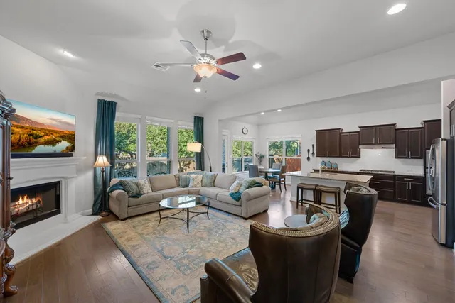 a living room with fireplace furniture and a flat screen tv