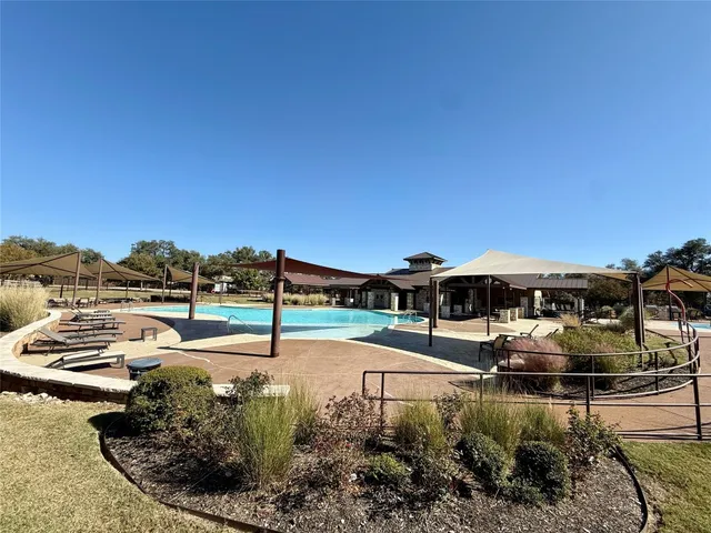 a view of a swimming pool with a patio