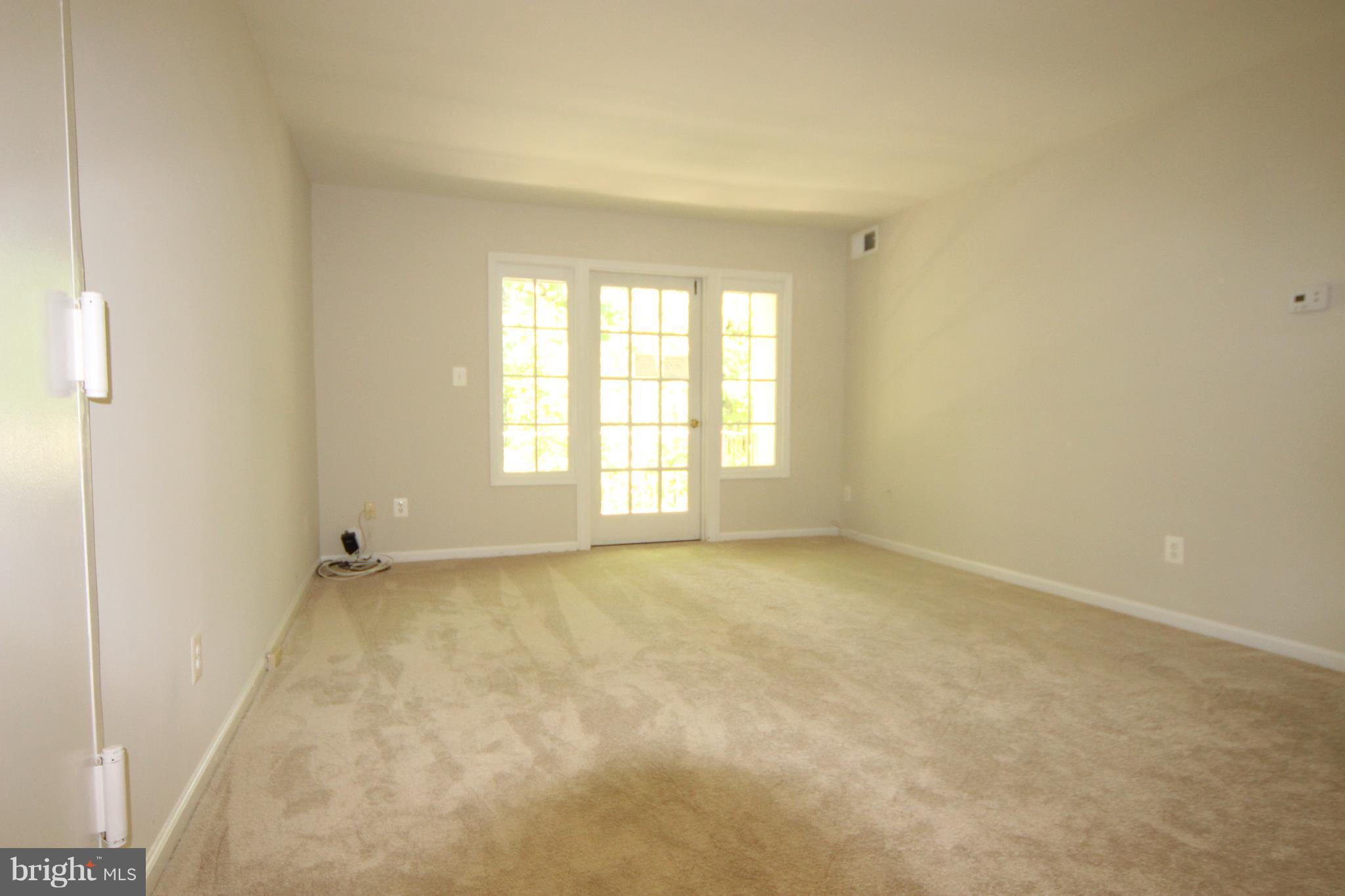5903 Kingsford Road, Unit H Springfield, VA 22152 - Photo 2 of 18 an empty room with a window