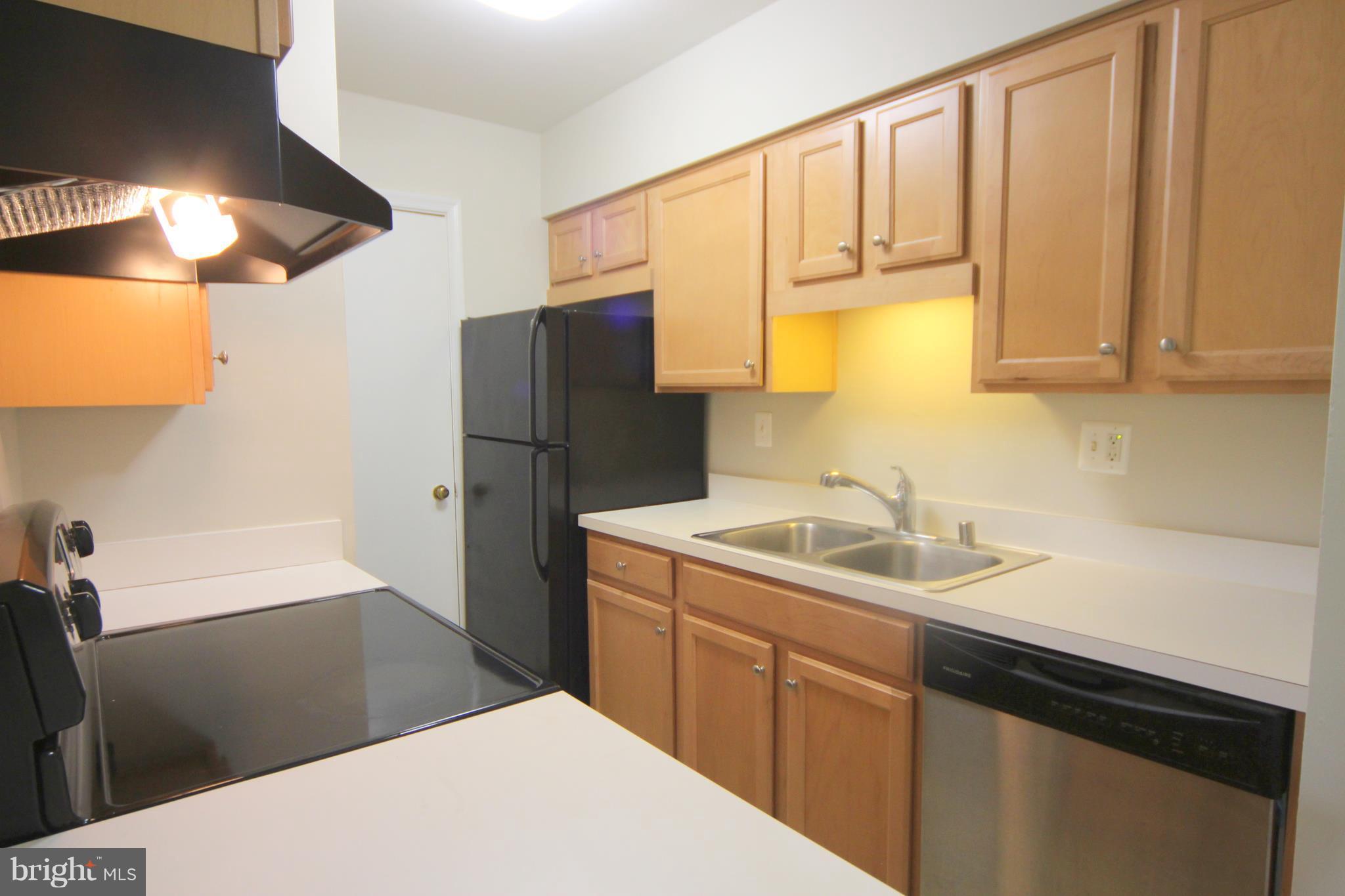 5903 Kingsford Road, Unit H Springfield, VA 22152 - Photo 4 of 18 a kitchen with a sink and a refrigerator