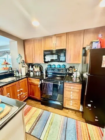 a kitchen with stainless steel appliances granite countertop a stove a sink and a refrigerator