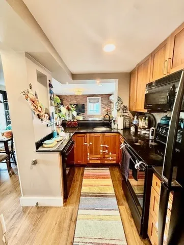 a kitchen with stainless steel appliances granite countertop a stove and a sink