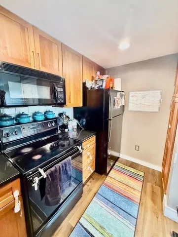 a kitchen with stainless steel appliances granite countertop a refrigerator and a stove