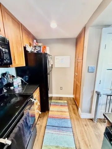 a kitchen with refrigerator and window