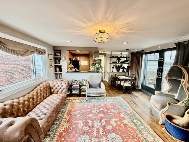 a bedroom with furniture and a large window