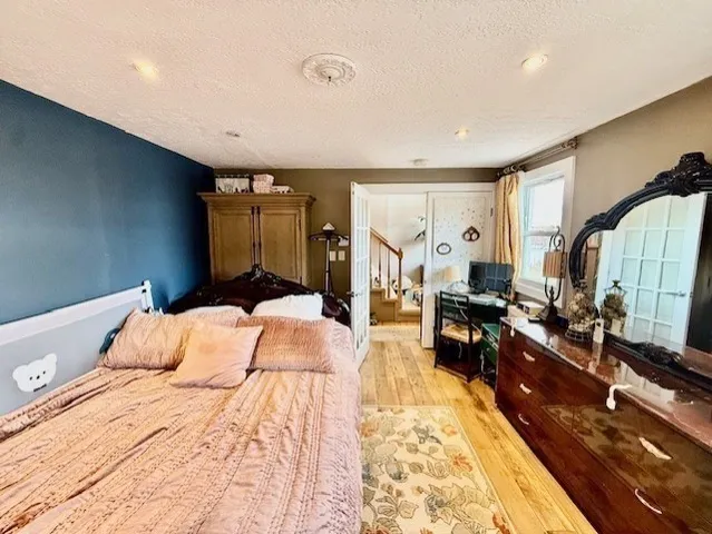 a bed sitting in a room next to a window