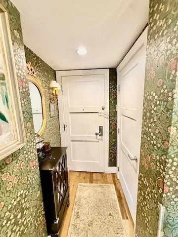 a spacious bathroom with a granite countertop sink a mirror and shower