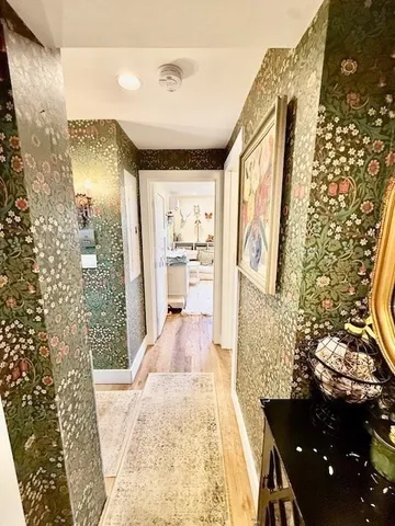 a living room with furniture chandelier and a flat screen tv