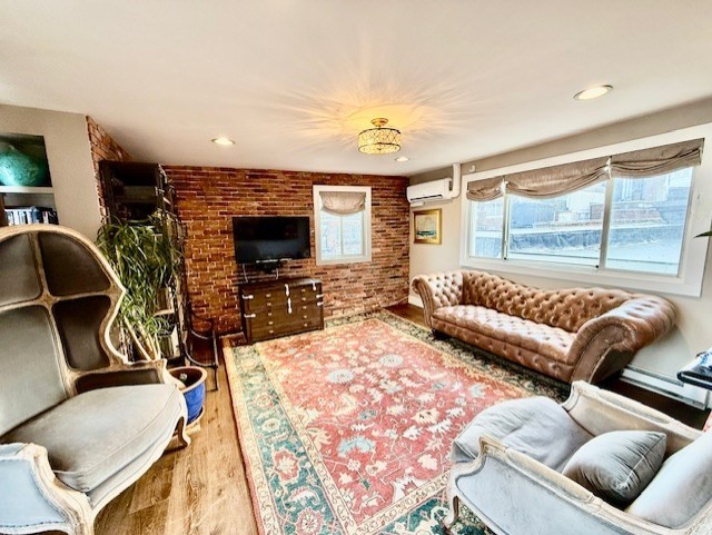 480 Commercial Street, Unit 5A Boston, MA 02109 - Photo 5 of 41 a living room with furniture and a flat screen tv
