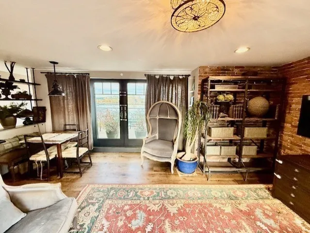 a living room with furniture a rug and decor