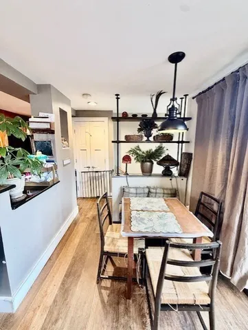 a view of a dining room with furniture window and wooden floor