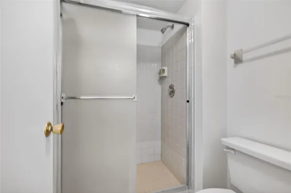 a bathroom with a shower and a toilet