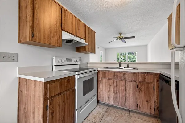 a kitchen with stainless steel appliances granite countertop a sink stove and cabinets