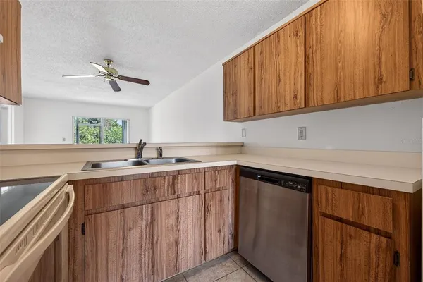 a kitchen with a sink cabinets and window