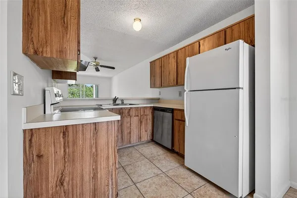 a kitchen with a sink a refrigerator and a stove