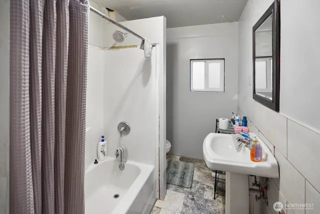 a bathroom with a sink a mirror and a toilet